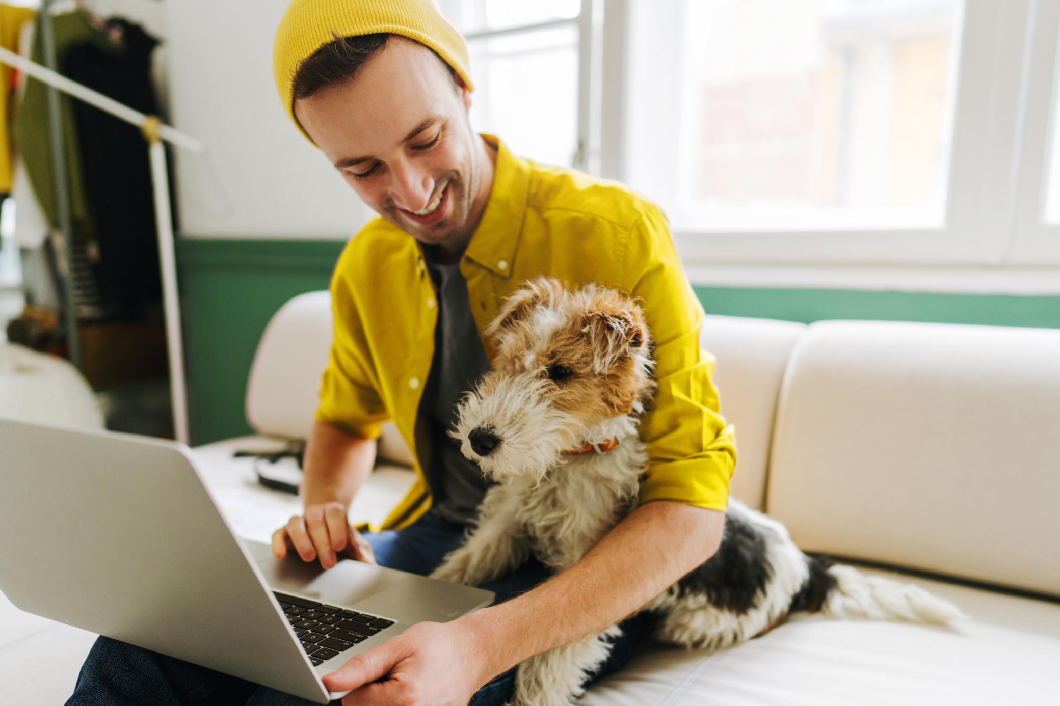 Junger Mann und sein Hund geben sich gegenseitig High Five